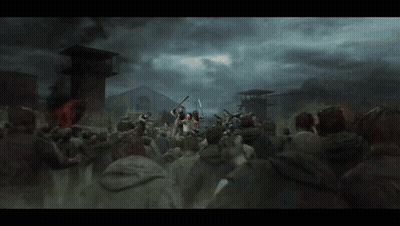 A Crowd Of People Are Gathered In Front Of A Building With A Fire In The Background GIF