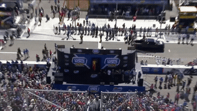 A Crowd Of People Are Gathered In Front Of A Stage That Says 500 On It GIF