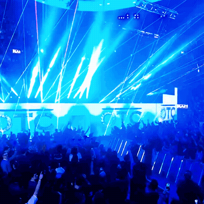 A Crowd Of People Are Gathered In Front Of A Wall That Says Otc On It GIF