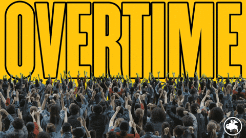 A Crowd Of People Are Gathered In Front Of A Yellow Background With The Word Overtime On It GIF