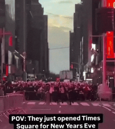 A Crowd Of People Are Gathered On A City Street With The Caption " They Just Opened Times Square For New Years Eve " GIF