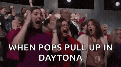 A Crowd Of People Are Screaming In A Theater While Watching A Show . GIF