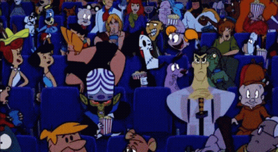 A Crowd Of People Are Sitting In A Movie Theater Watching A Movie . GIF