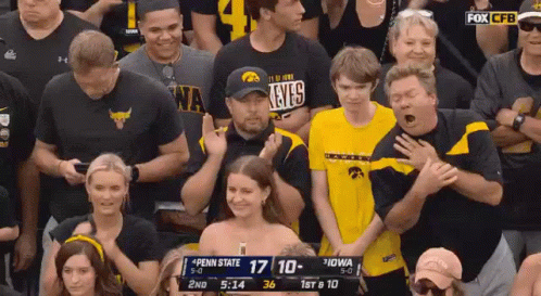 A Crowd Of People Are Watching A Penn State Vs Iowa Game GIF