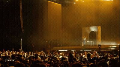 A Crowd Of People At A Concert With The Word Cancabella On The Bottom Right GIF