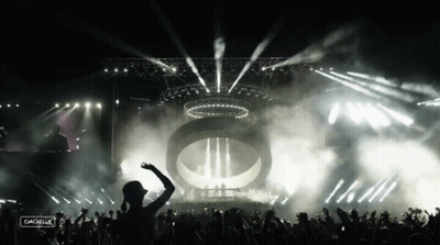 A Crowd Of People At A Concert With The Word Coachella On The Bottom Left GIF
