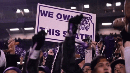 A Crowd Of People Hold Up A Sign That Says We Own This State GIF