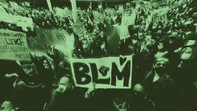 A Crowd Of People Holding Up Signs Including One That Says Blm On It GIF