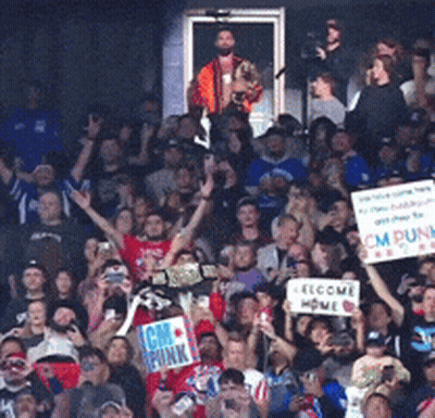 A Crowd Of People Holding Up Signs Including One That Says I Am Punk GIF