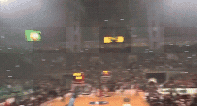 A Crowd Of People In A Stadium With Smoke Coming Out Of The Stands And A Sign That Says ' A ' GIF