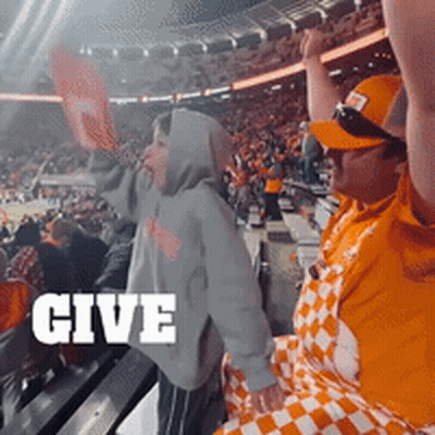A Crowd Of People In A Stadium With The Word Give In White GIF