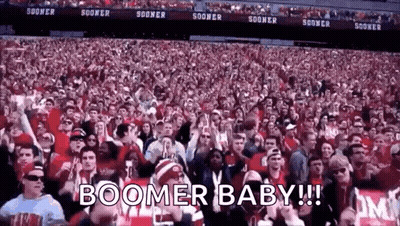 A Crowd Of People In A Stadium With The Words Boomer Baby ! GIF