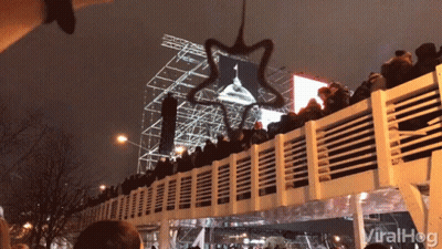 A Crowd Of People Sitting On A Bridge With The Word Viralhog Written On The Bottom GIF