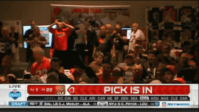 A Crowd Of People Watching A Football Game With A Pick Is In Banner On The Screen GIF