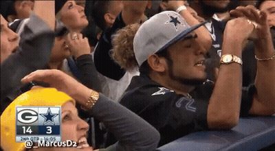 A Crowd Of People Watching A Football Game With The Score 14 3 GIF