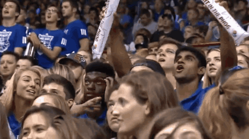 A Crowd Of People Watching A Game With A Banner That Says " Just On The Phog " GIF