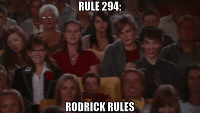 A Crowd Of People Watching A Show With Rodrick Rules Written In The Corner GIF