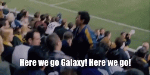 A Crowd Of People Watching A Soccer Game With The Words `` Here We Go Galaxy Here We Go '' . GIF