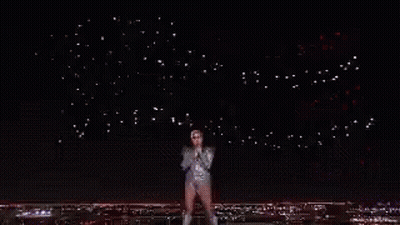 A Crowd Of People Watching A Wrestling Match In A Stadium GIF
