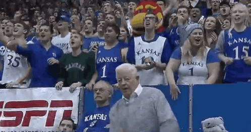 A Crowd Of People Wearing Kansas Jerseys Are Watching A Game GIF