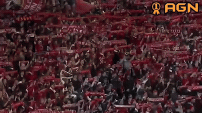 A Crowd Of People Wearing Red Scarves With Ynwa Written On It GIF