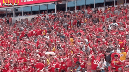 A Crowd Of People Wearing Red Shirts With The Numbers 15 And 87 On Them GIF
