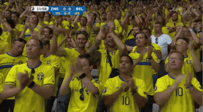 A Crowd Of People Wearing Yellow Shirts With The Number 10 On The Front GIF