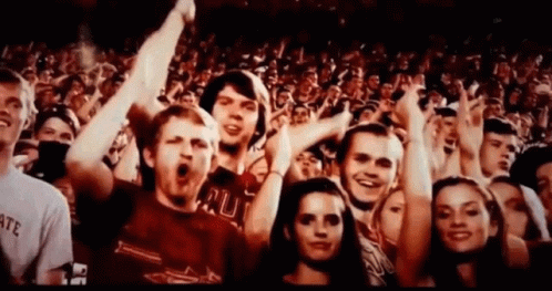 A Crowd Of People With One Man Wearing A Shirt That Says ' Rut ' On It GIF