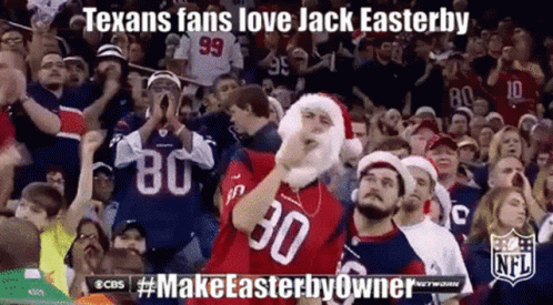 A Crowd Of Texans Fans Wearing Santa Hats And Jerseys With The Number 30 On Them GIF