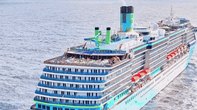 A Cruise Ship Is Floating In The Ocean And Has A Green Chimney On Top GIF
