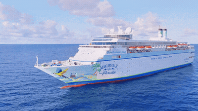 A Cruise Ship That Says Msc Paradise On The Side GIF