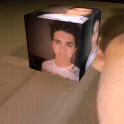 A Cube With A Picture Of A Man In It GIF