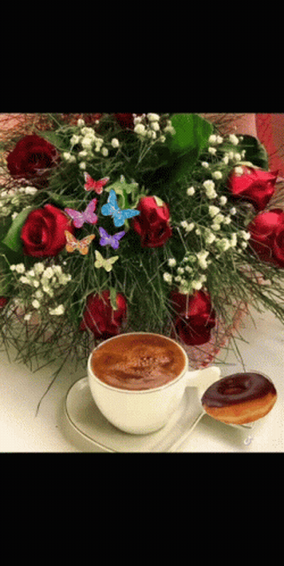 A Cup Of Coffee Is On A Saucer Next To A Bouquet Of Flowers GIF