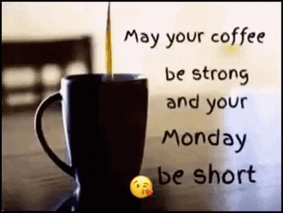 A Cup Of Coffee Is On A Table With A Quote That Says `` May Your Coffee Be Strong And Your Monday Be Short '' . GIF