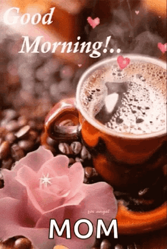 A Cup Of Coffee Is Sitting On A Saucer Next To A Pink Flower . GIF