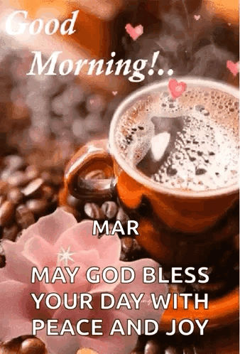 A Cup Of Coffee Is Sitting On Top Of A Table Next To A Flower . GIF