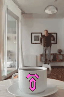 A Cup Of Coffee On A Saucer With A Pink Letter O On It GIF
