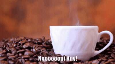 A Cup Of Coffee Sits On A Pile Of Coffee Beans With The Words Ngooooopi Kuy Above It GIF