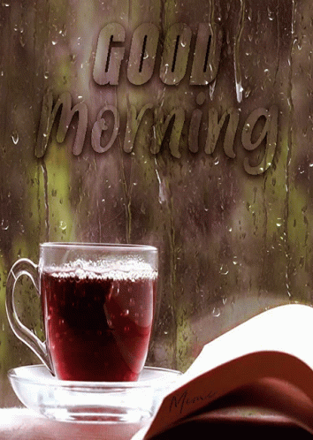 A Cup Of Coffee Sits On A Saucer Next To A Book That Says Good Morning On It GIF