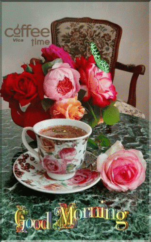 A Cup Of Coffee Sits On A Saucer Next To A Bouquet Of Pink Roses And The Words Good Morning GIF