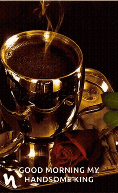 A Cup Of Coffee Sits On A Saucer Next To A Rose GIF