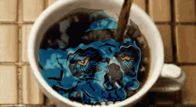 A Cup Of Coffee With A Blue Skull In It GIF