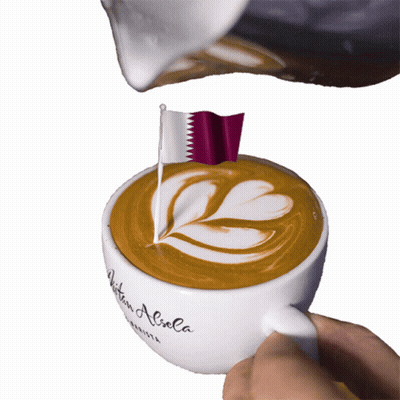 A Cup Of Coffee With A Flag On Top Of It GIF
