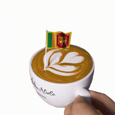 A Cup Of Coffee With A Flag On Top That Says Written Aliola GIF