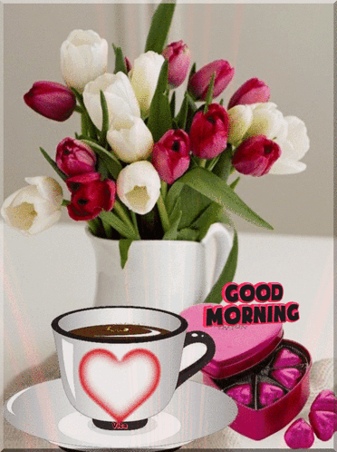 A Cup Of Coffee With A Heart On It Is Next To A Vase Of Flowers And A Box Of Chocolates That Says Good Morning GIF