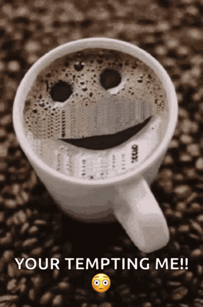 A Cup Of Coffee With A Smiley Face On It And The Words Your Tempting Me GIF