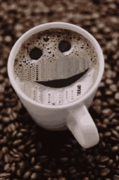 A Cup Of Coffee With A Smiley Face On The Top GIF