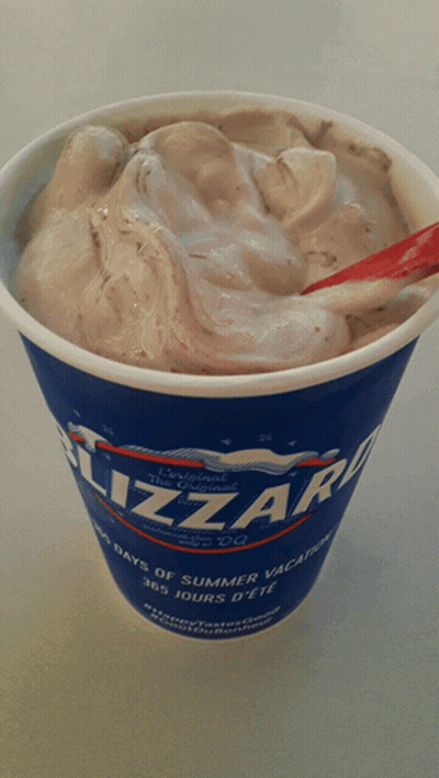 A Cup Of Dairy Queen Blizzard Ice Cream With A Red Spoon GIF
