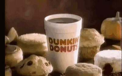 A Cup Of Dunkin Donuts Coffee Surrounded By Donuts And Muffins GIF