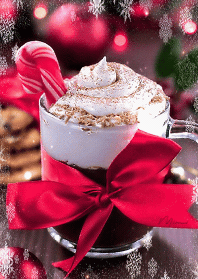 A Cup Of Hot Chocolate With A Red Bow And Candy Cane GIF